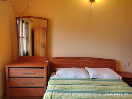 a bedroom with a bed and a dresser and a mirror at BEACH APARTMENT 3 in Salcete