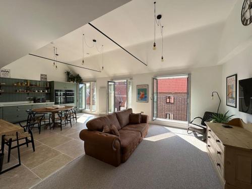 a living room with a couch and a table at The Penthouse at Purfleet in King's Lynn