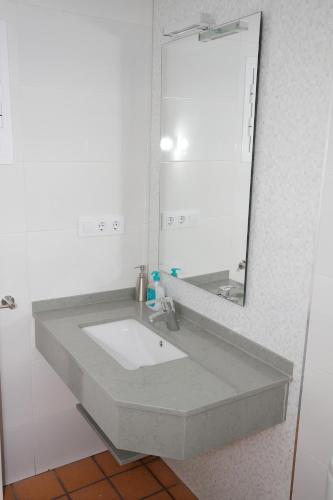a bathroom with a sink and a mirror at Chalet Los 20 Pilares in Ubrique