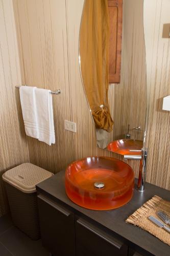 a bathroom with an orange sink on a counter at Stella Maris Case Vacanze in Balestrate