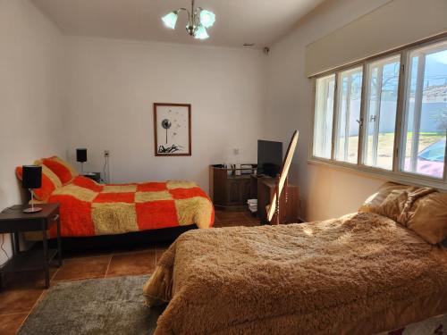 a bedroom with two beds and a window at LOS OLIVARES. SAN LORENZO in Salta