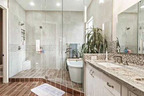 a bathroom with a shower and a sink and a tub at Phoenix Home with heated pool, desert views & hot tub in Anthem