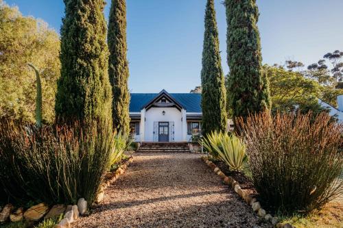a white house with trees in front of it at White Water Farm in Stanford