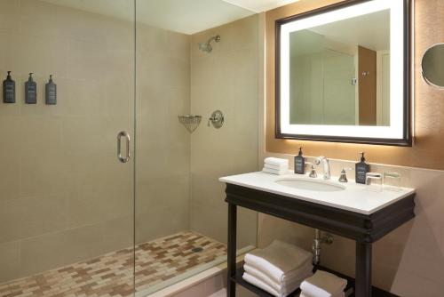 a bathroom with a sink and a shower at Sheraton Parkway Toronto North Hotel & Suites in Richmond Hill
