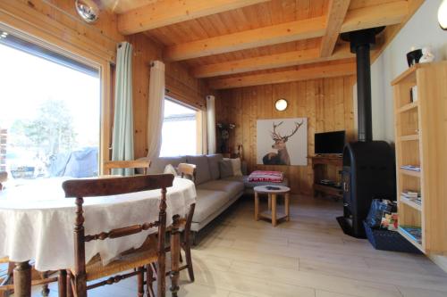 a living room with a couch and a table at Charmant petit chalet individuel in Briançon