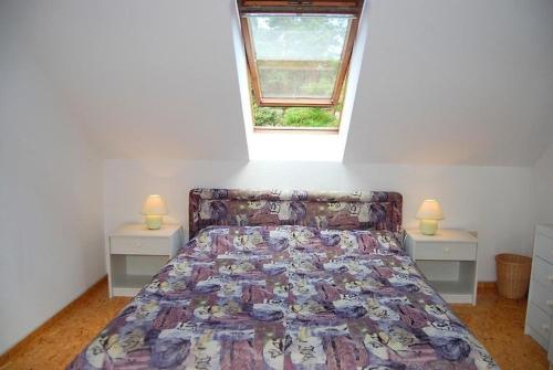 a bed in a room with two night stands and a window at Ferienpark am Darß - Apartmenthaus 3 in Fuhlendorf