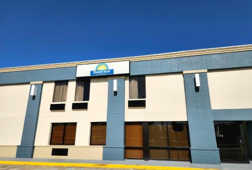 a front view of a building with a sign on it at Days Inn by Wyndham Slidell in Slidell