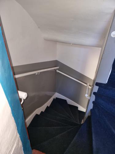 an empty stairs in a room with a stair case at Carrick - One Bed Apartment in Largs