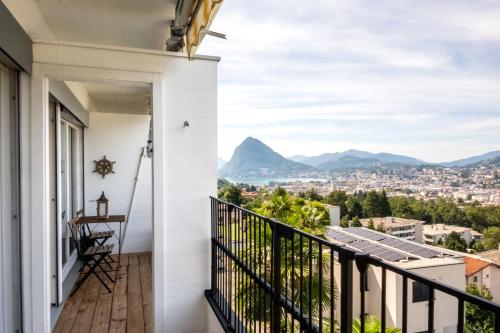 a balcony with a view of the mountains at Lugano Boat Apartment in Lugano