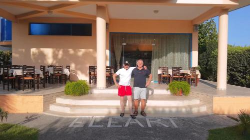 two men standing on steps in front of a building at Eleart in Golem