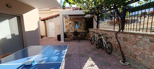 two bikes are parked next to a building at Boutique Eptalofos 15min from airoport and sea in Kouvarás