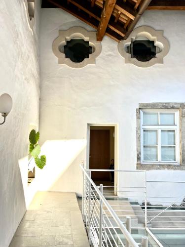 a building with a staircase and a window at Streiter Rooms in Bolzano