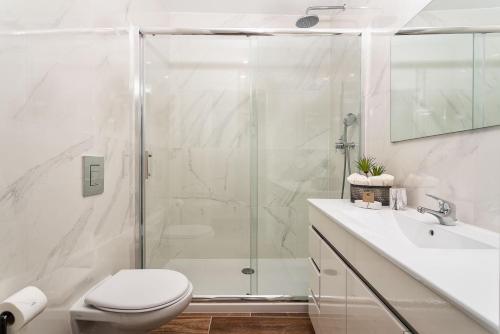 a bathroom with a shower and a toilet and a sink at Privilege Casa dos Capuchinhos, in the heart of Faro in Faro