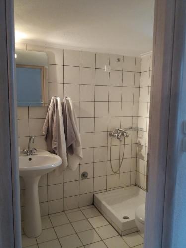 a bathroom with a sink and a shower and a toilet at BLEU- VERT in Prinos