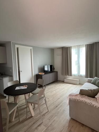 a living room with a table and chairs and a couch at La casa del Gallo in Pietra Ligure