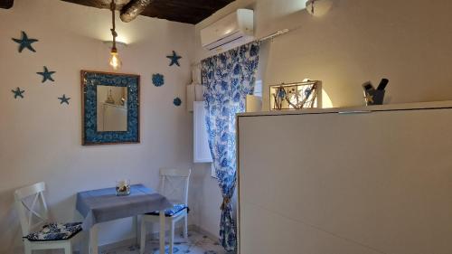 a room with a table and a mirror on the wall at La casa nella Torretta in Formia