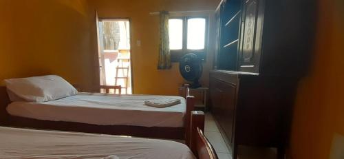 Postel nebo postele na pokoji v ubytování ROSÁRIO TEMPORADA Hostel