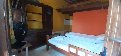 Postel nebo postele na pokoji v ubytování ROSÁRIO TEMPORADA Hostel