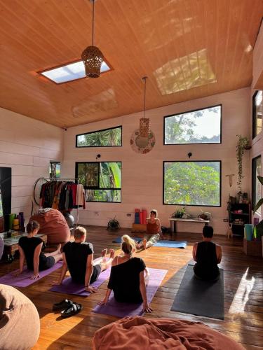 a group of people sitting in a room doing yoga at OutBox Inn in Monteverde Costa Rica
