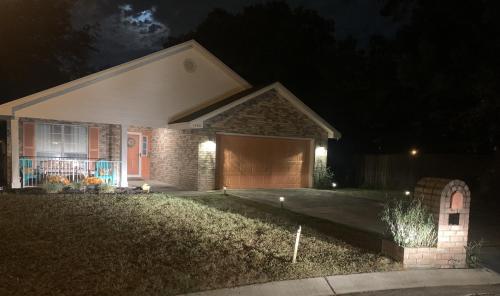 a house with a garage at night at D's Florida-Alabama Vacation Home Sleeps 14 Guests in Pensacola