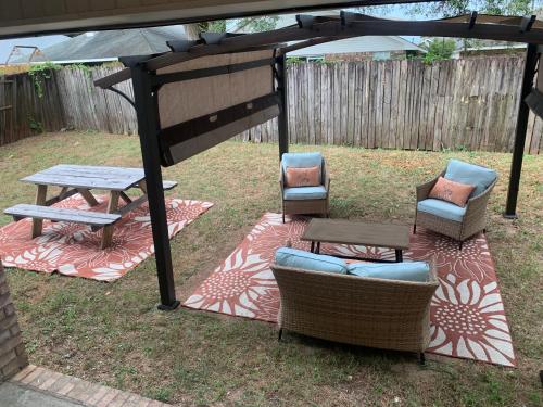 a picnic table and chairs under a gazebo at D's Florida-Alabama Vacation Home Sleeps 14 Guests in Pensacola