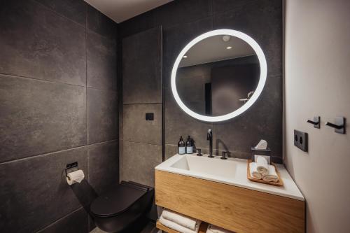 a bathroom with a sink and a toilet and a mirror at Highland Base Kerlingarfjöll in Kerlingarfjoll