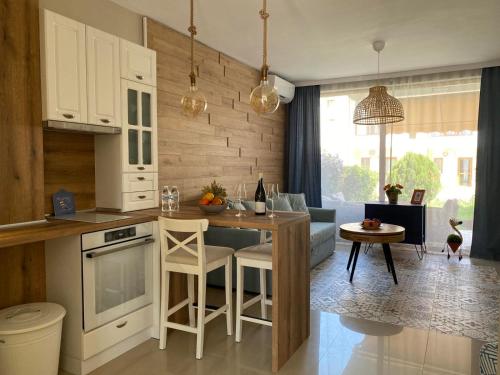 a kitchen and living room with a table and a couch at Villa Lavanda Golf in Balchik
