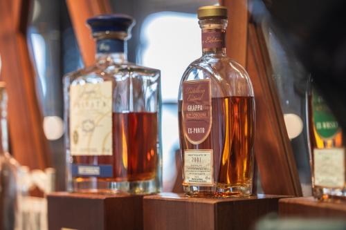 three bottles of whiskey on display on a shelf at Hotel Seehof Superior in Walenstadt