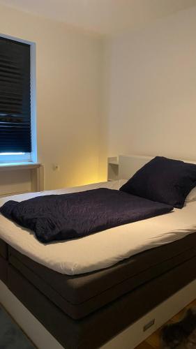 a large bed in a room with a window at City Fever in Hannover