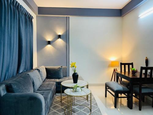 a living room with a couch and a table at Serviced Apartment near Medanta by BedChambers in Gurgaon