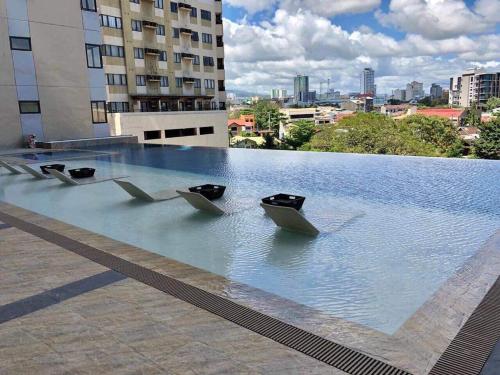 a pool of water on top of a building at Nice location in the persimmon condo in Cebu City