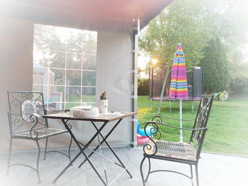 a patio with a table and chairs and a yard at Il Martinetto Bed & Breakfast in Cantarana
