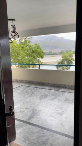 an open door to a balcony with a view at PINETOP RESORT in Khanpur