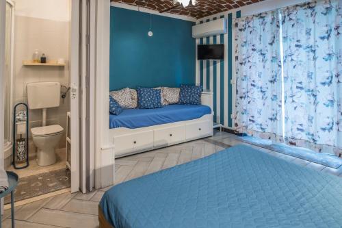 a blue bedroom with a bed and a toilet at Il Martinetto Bed & Breakfast in Cantarana