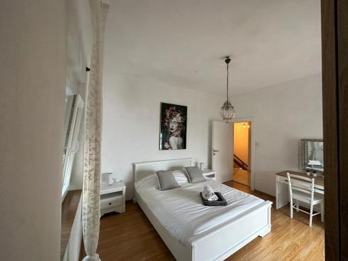 Un dormitorio con una cama blanca y una mesa. en Casa Blanca, Biograd na Moru, en Biograd na Moru