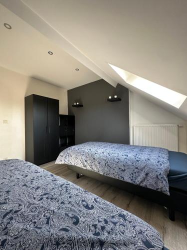 - une chambre avec 2 lits et une lucarne dans l'établissement The 75 renovated work or holiday home, à Comines