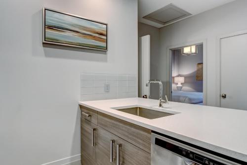a kitchen with a sink and a microwave at Parker's Collection - 4 Bedroom in Savannah