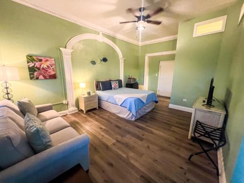 a bedroom with a bed and a couch in a room at Victoria House in Frederiksted