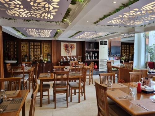 a restaurant with wooden tables and chairs and a bar at Pinnacle boutique villas in Galle