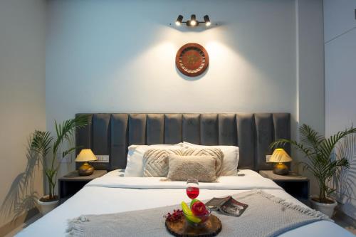 a bedroom with a bed with a tray of food on it at Serviced Apartment near Medanta by BedChambers in Gurgaon