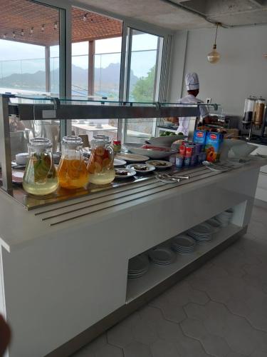 a counter in a kitchen with food in jars at Ouril Mindelo in Mindelo