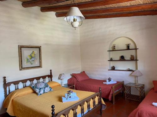 a bedroom with two beds and a couch at El Ensueño in Tilcara