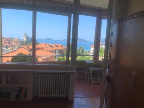 a room with windows and a view of the ocean at La Casa di Loris in Lerici