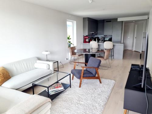 a living room with a white couch and a table at Private room in shared Modern Apartment - Oslo Hideaway in Oslo