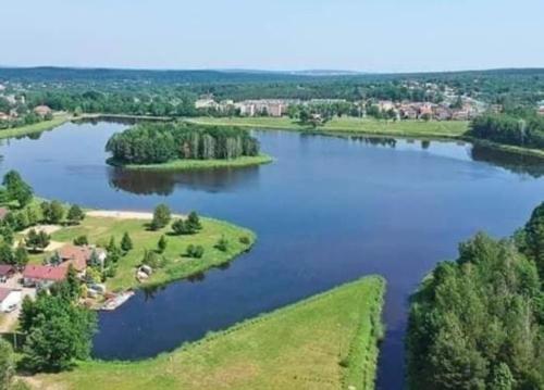 an aerial view of a lake with trees and houses at Suchedniów mieszkanie in Suchedniów