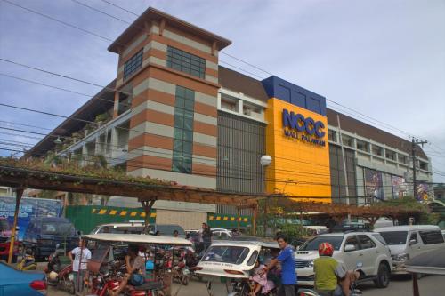 a building with a lot of traffic in a city at Deep Forest Garden Hotel in Puerto Princesa City