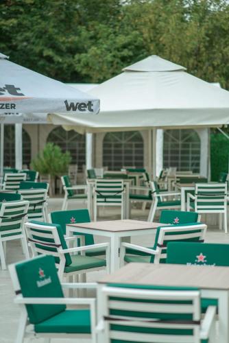 a bunch of chairs and tables with a gazebo at HOTEL VITAL in Baile Felix