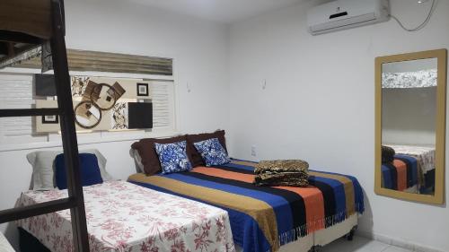 a bedroom with a bed and a bunk bed at Pousada e Hostel sol e mar in João Pessoa