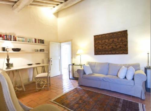 a living room with a couch and a table at PodereVicoBasso Siena in Siena