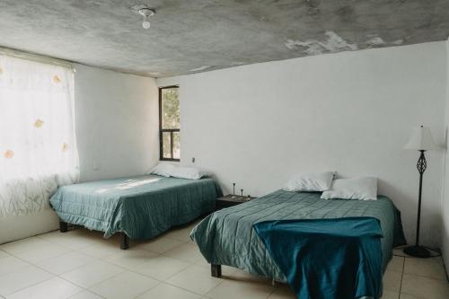 Ένα ή περισσότερα κρεβάτια σε δωμάτιο στο Pinitos Ranch Country House